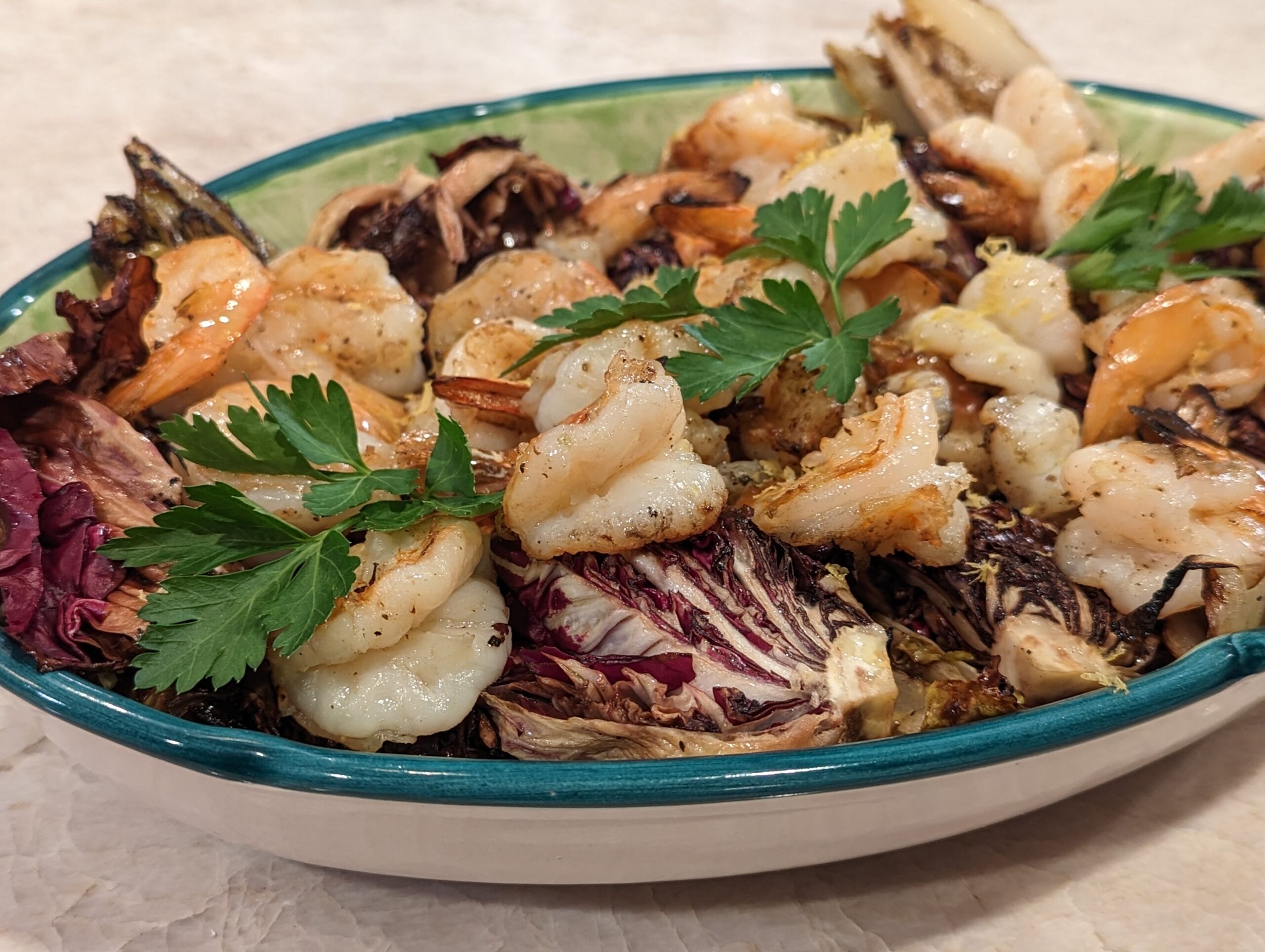 A dish that combines the tender and juicy taste of grilled shrimp with the crisp bitterness of radicchio and endive, topped with balsamic glaze.